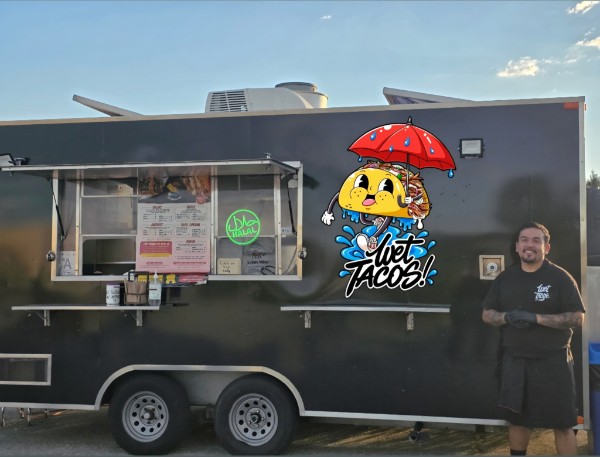 Francisco standing beside the Wet Tacos trailer
